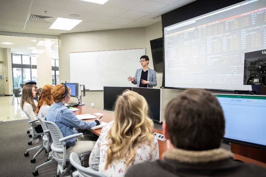 Business professor lecturing to business students. 