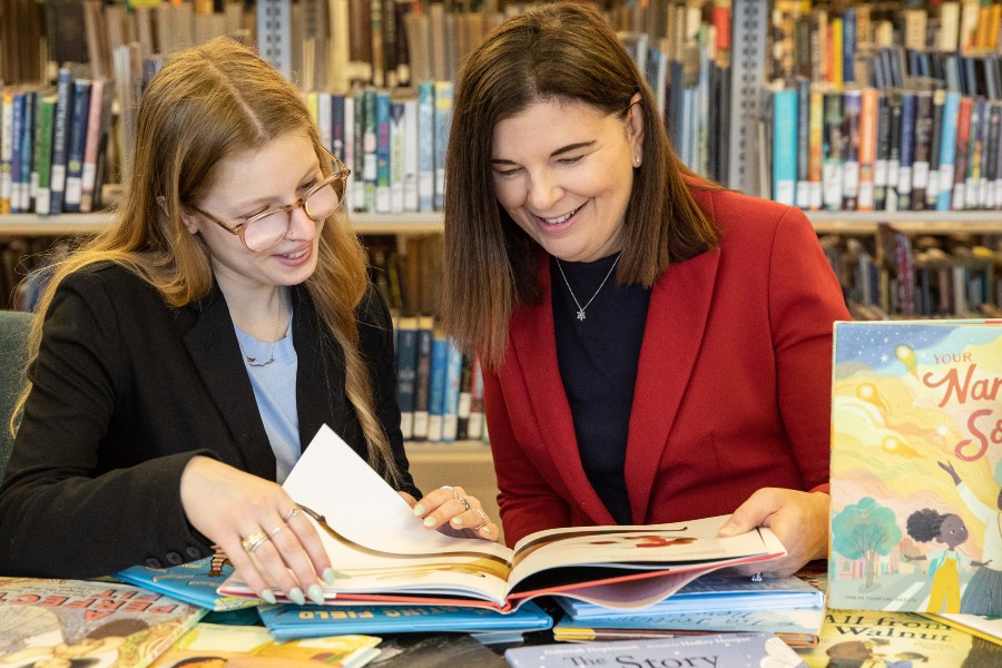 Emma Salvitti and Dr. Jeanne Fain look over children's books