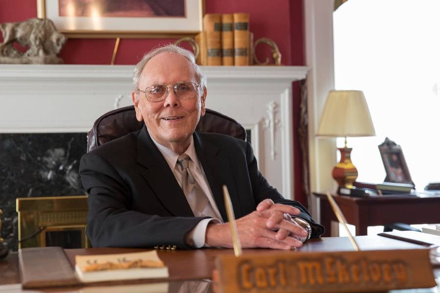 Photo of Carl McKelvey sitting at his desk. 