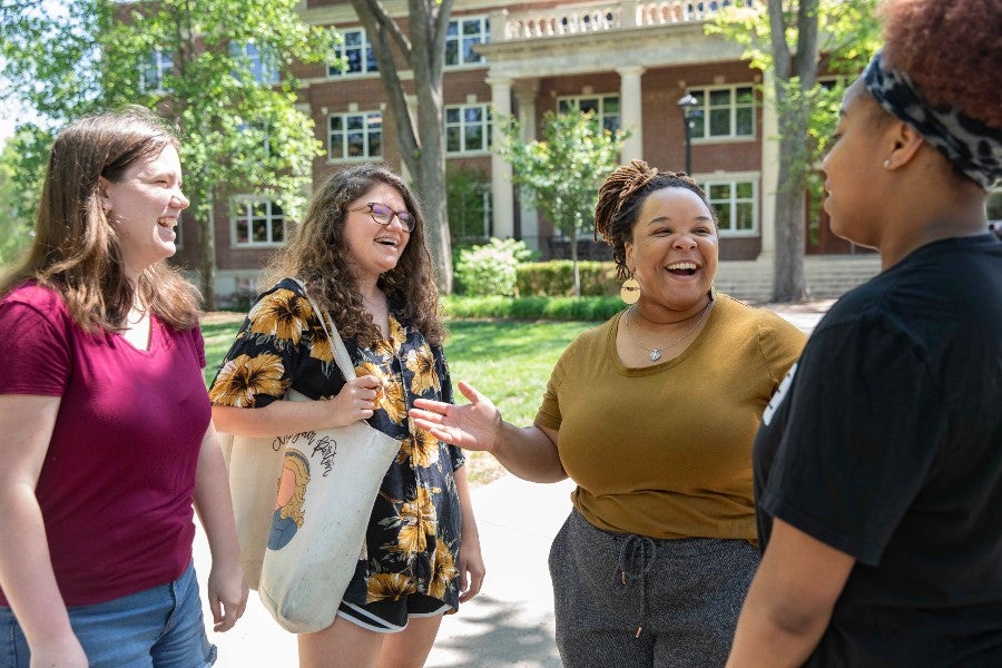 Asa Bailey talking with students in Bison Square