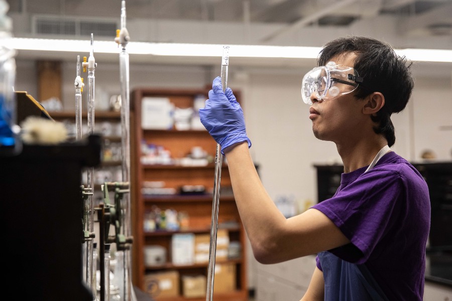 Student Aaron Hardy at work in the chemistry lab on his experiment