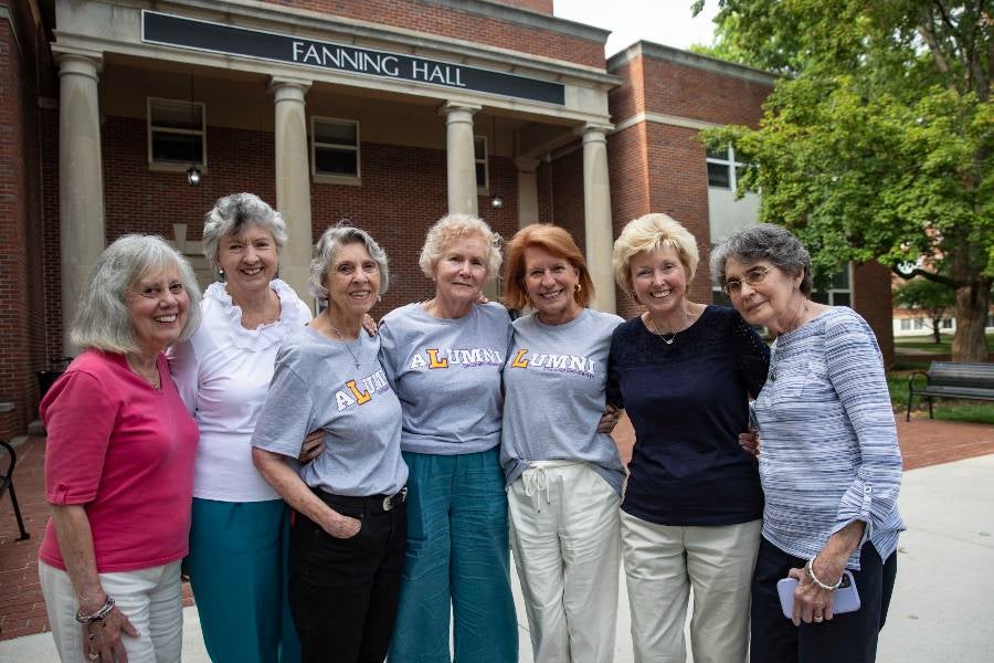 Alumni alumni standing in front of Fanning Hall.