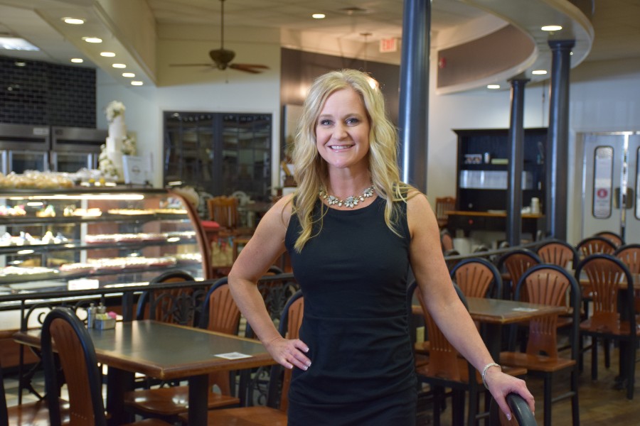 Kristi Stone in front of the pastry counter of Puffy Muffin.