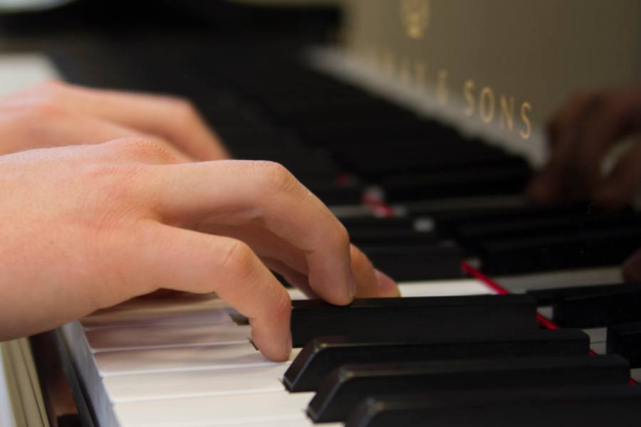 Student playing the piano 