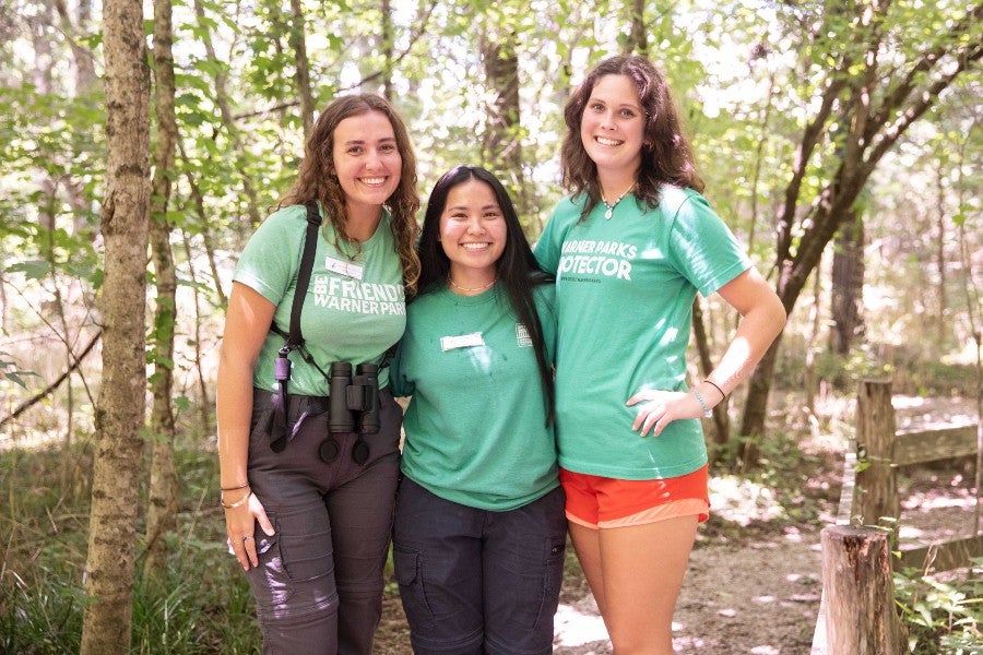 Amelia Browning, Anna Sawyer, Anna Money standing together in the park