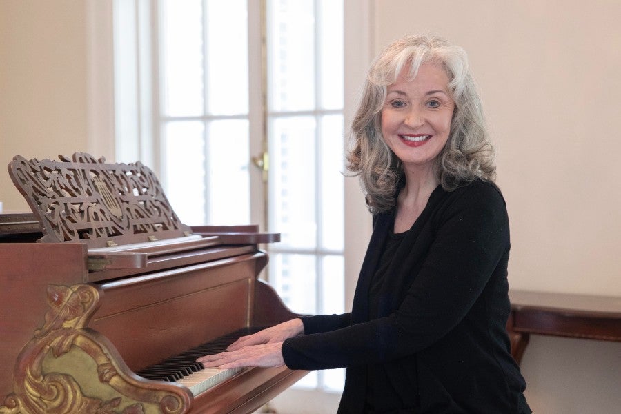 Janet McMahan seated at the piano