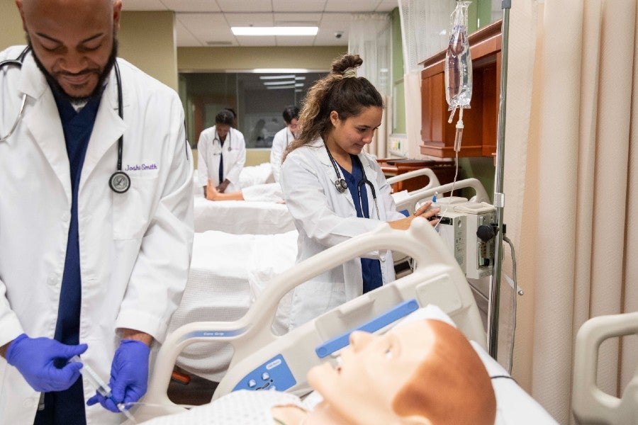 Nursing student at work in the patient simulation lab