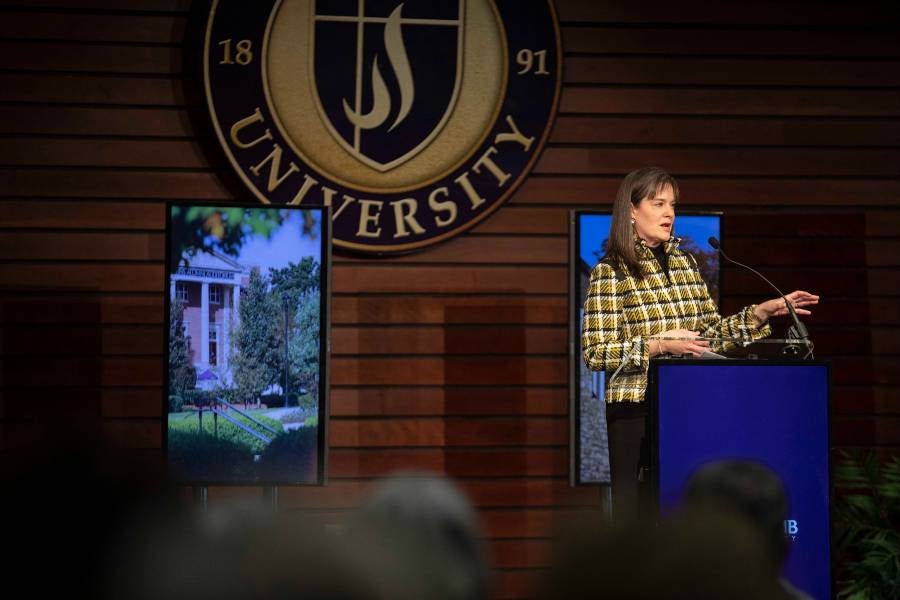 President McQueen speaking in George Shinn Center. 