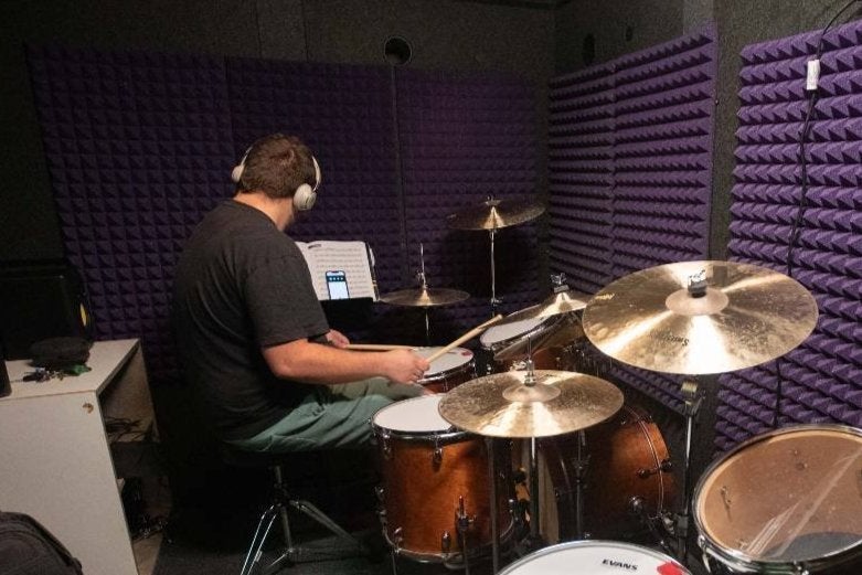 Student drummer practicing in the Whisper Room™