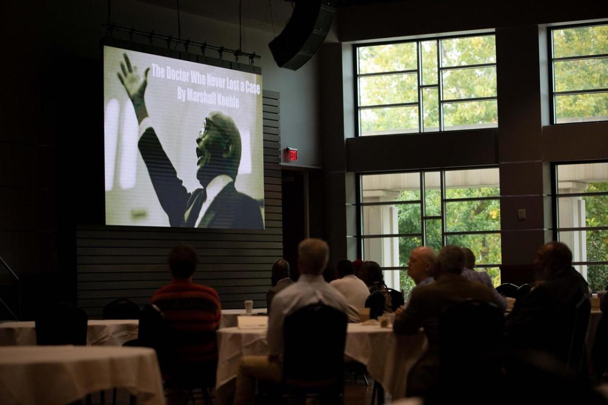 Image of Keeble on screen as part of a presentation