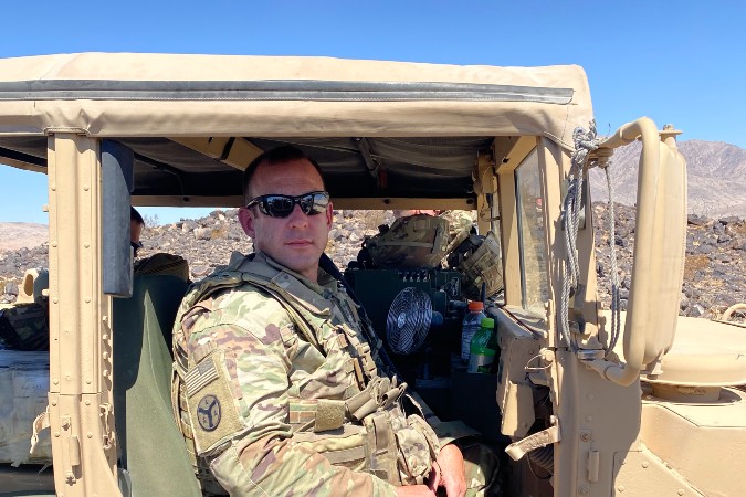 Lt. Col. Tippen sitting in Jeep