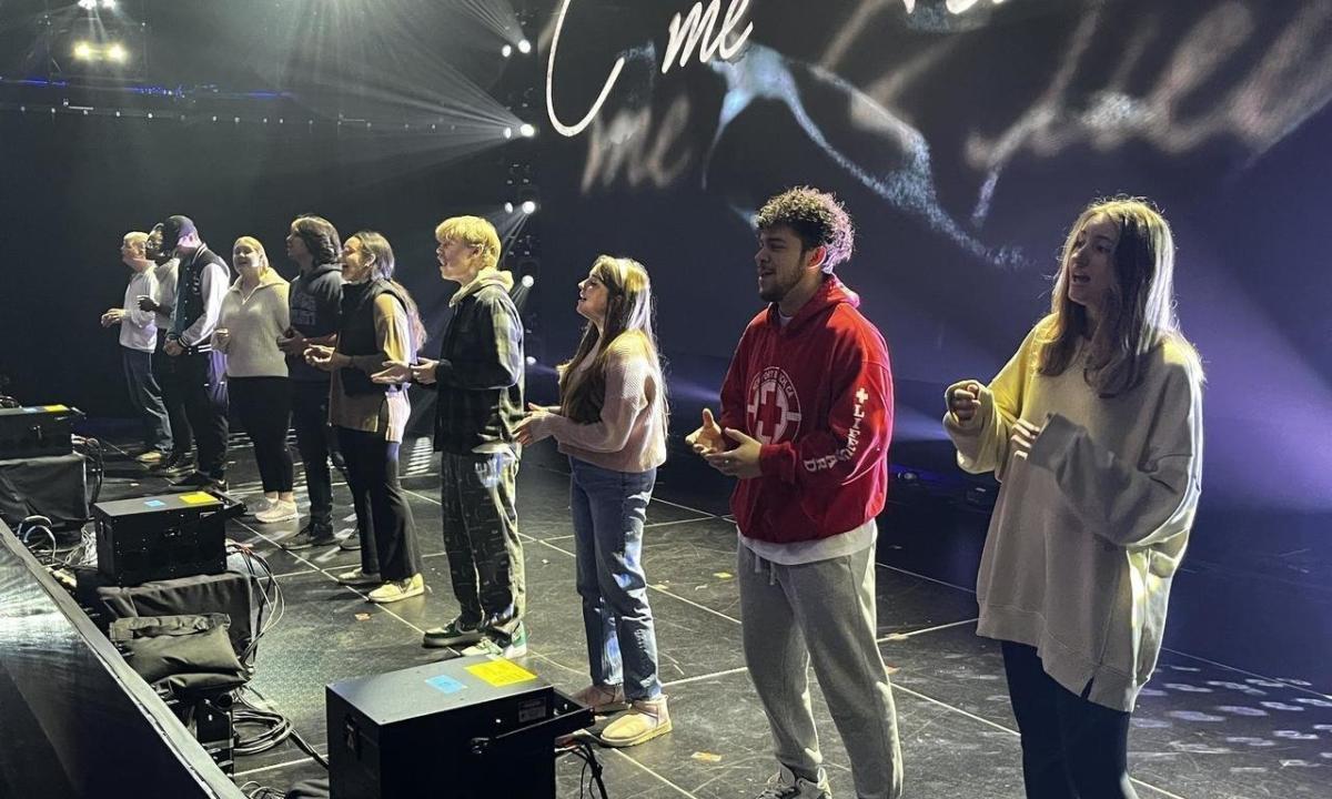 Sanctuary student singers rehearsing on stage at the Dove Awards.