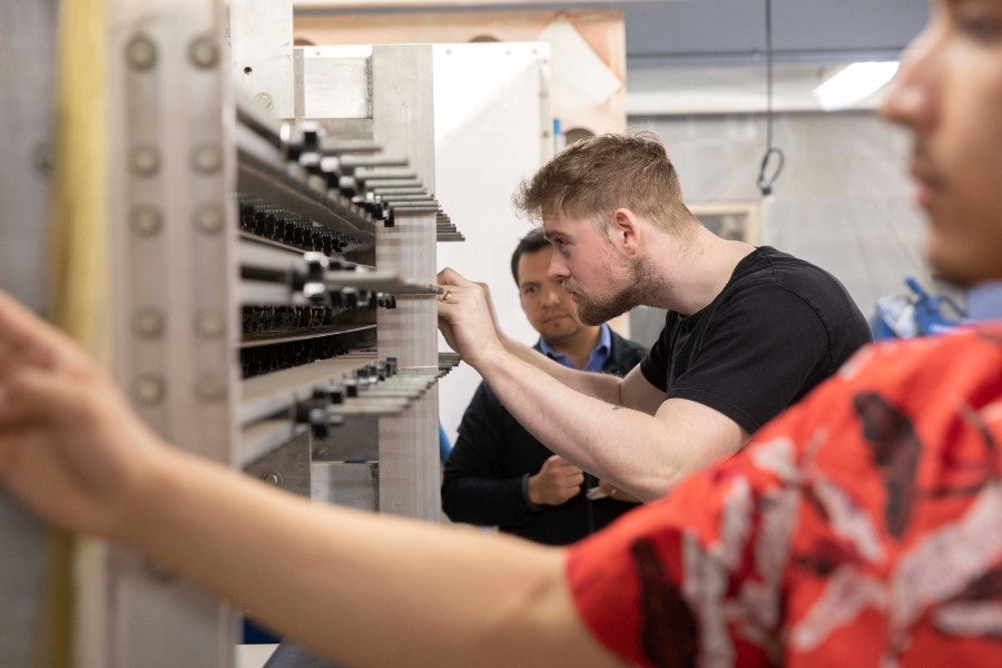 Max David Collao supervising students at the wind tunnel