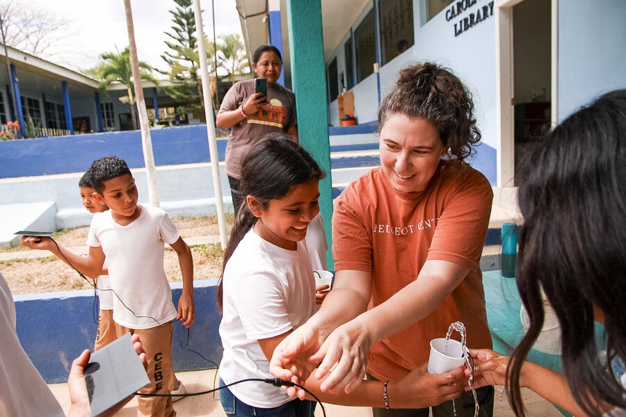 HOI team member with members of the community.