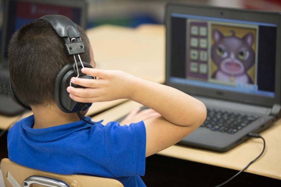 Child sitting at computer