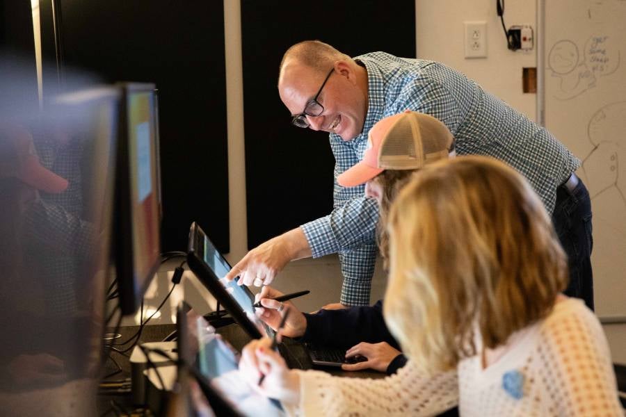 Animation professor works with students.