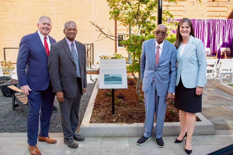 Fred Gray and Harry Kellum post with the new replica of the city's historical marker with Lipscomb officials
