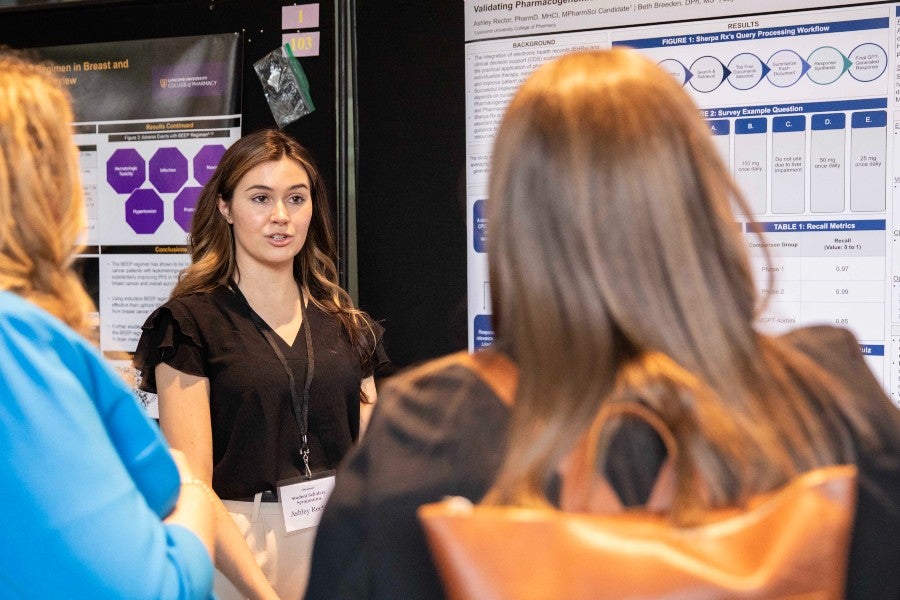 Graduate Ashley presenting a poster at Lipscomb's student research symposium