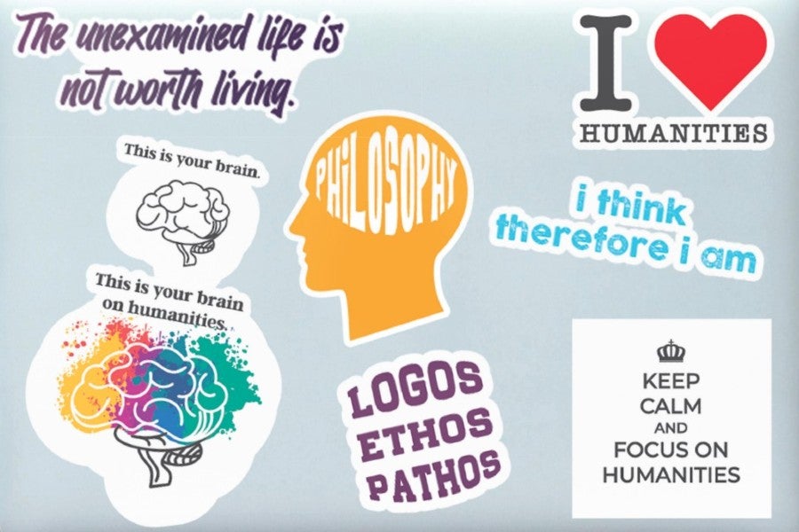 stickers promoting concepts in the humanities stuck on a laptop computer back
