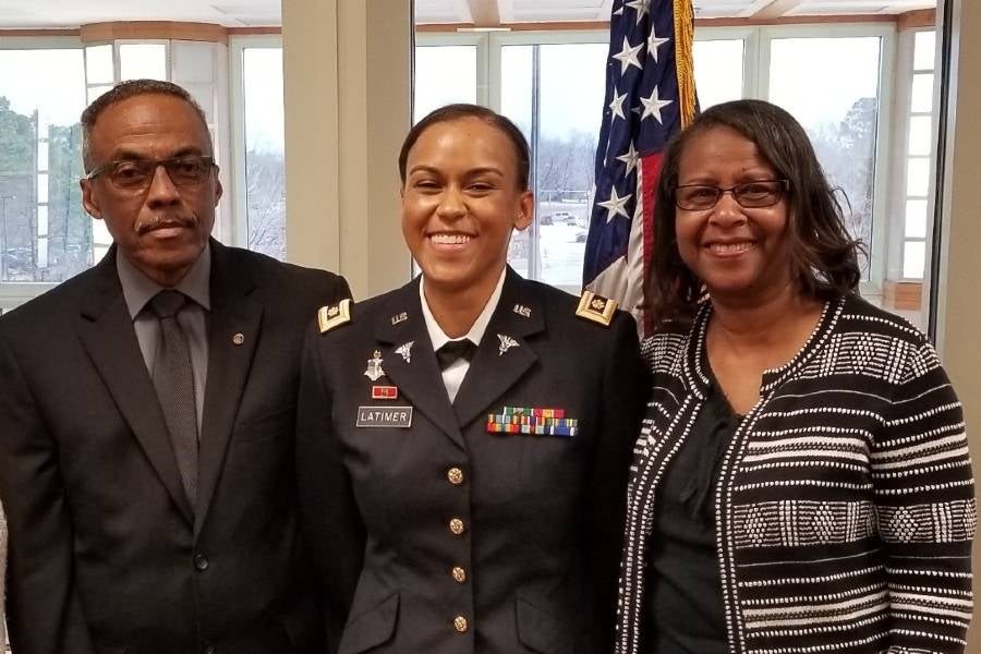 Tom and Dorothy Latimer with their daughter, Brittany, center, at her Army promotion ceremony.