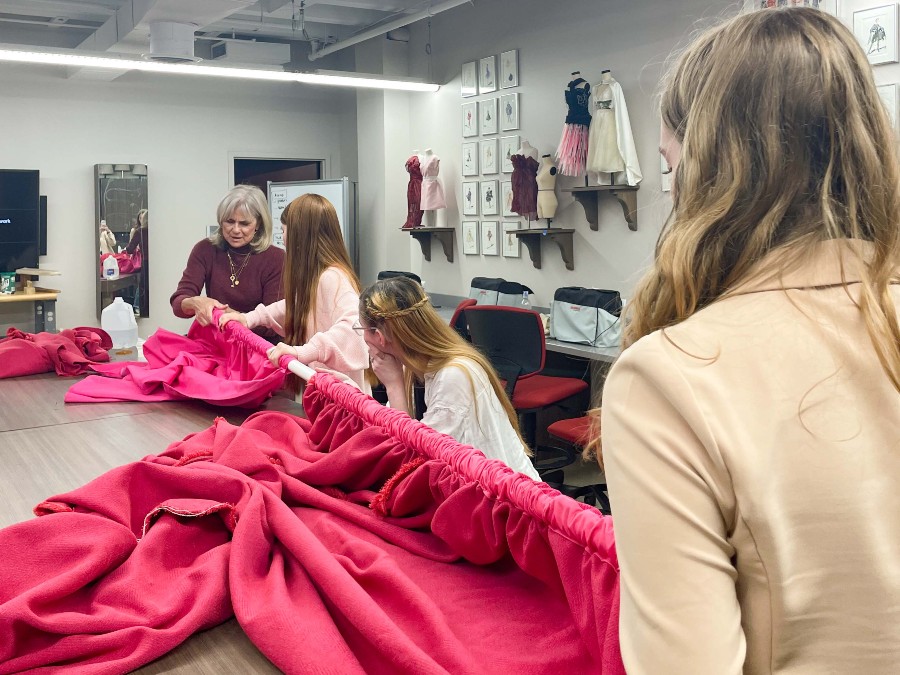 Students working on fashion material during a workshop