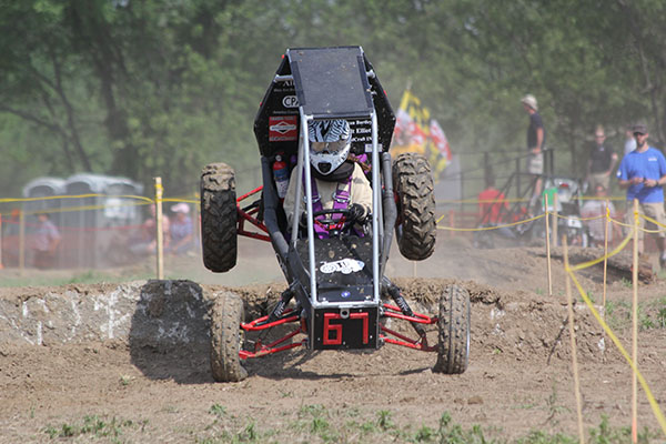 A student races the vehicle that her and her team built for the Baja SAE competition