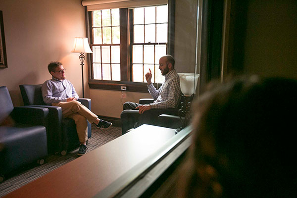 A counselor and a patient sit in an office talking