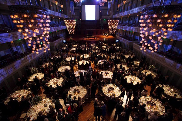 Individuals mingling at and event inside the Nashville Symphony