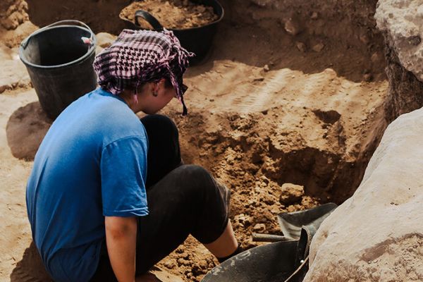 student digging in ancient near east