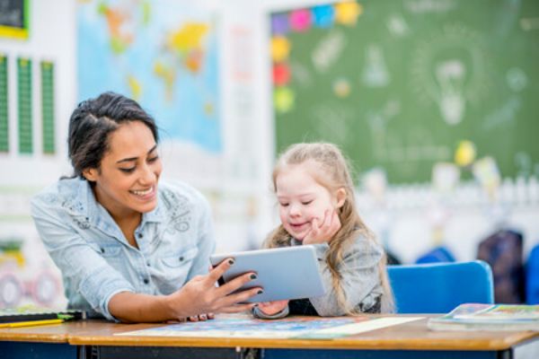 Teacher working on iPad with student