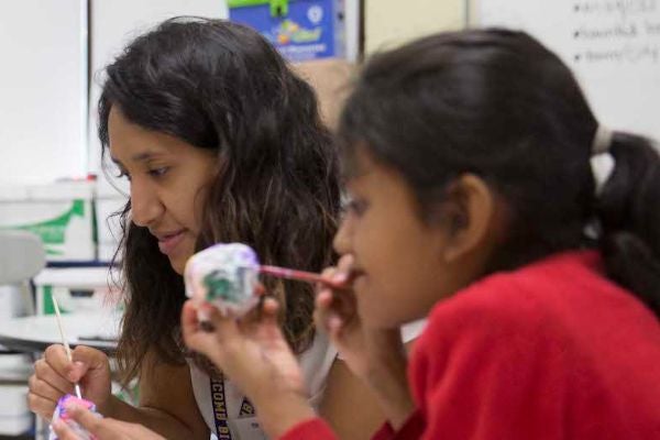 Graduate student in a classroom with a gifted student