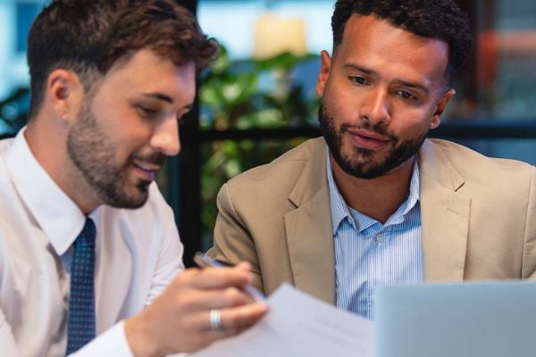 two business students working together at a computer