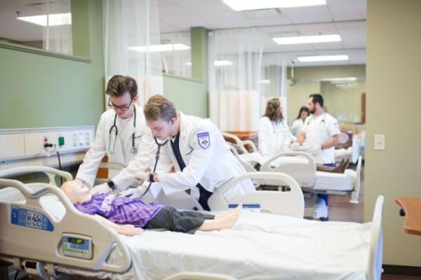 students working on a practice patient