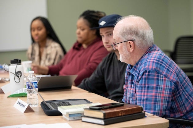 Graduate students in class discussing bible