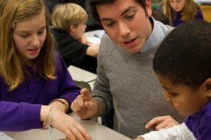 Student teachers interact with students in the classroom.