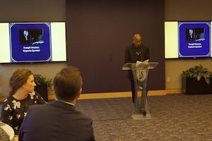 Man standing in front of podium. 