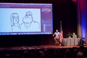 Man in front of screen describing sketches. 