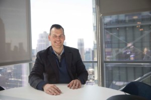 alum Chad Estep sitting inside the ETRADE office in New York City