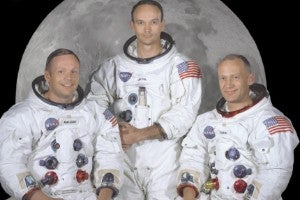 Apollo 11 astronauts in space suits.