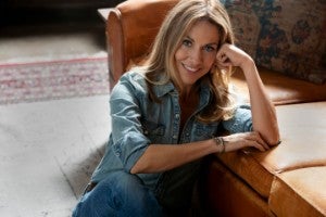 Sheryl Crow sitting in chair.