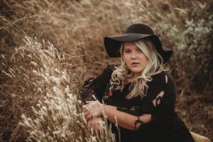 Singer Kelle Cates in hay