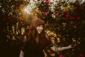 Ele Ivory standing in a garden