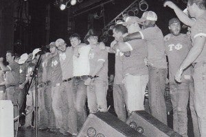 Photo of Tau Phi members standing on the stage