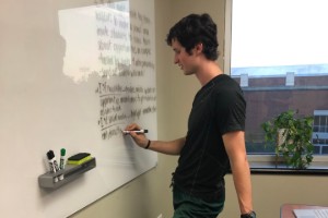 Student writing on white board