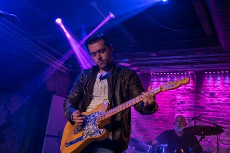 Patrick Carpenter playing a guitar. 