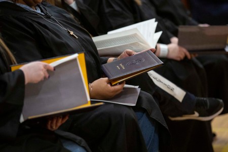 Graduates holding diplomas