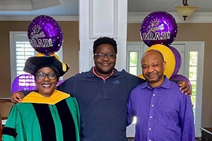 Carl Mhlanga with his parents at a graduation party