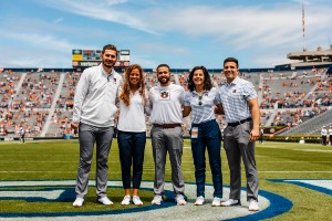 Kate Nese with group on Auburn sidelines