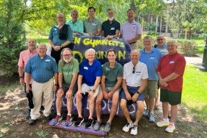 Attendees of the gymnastics team reunion posing at the Bison