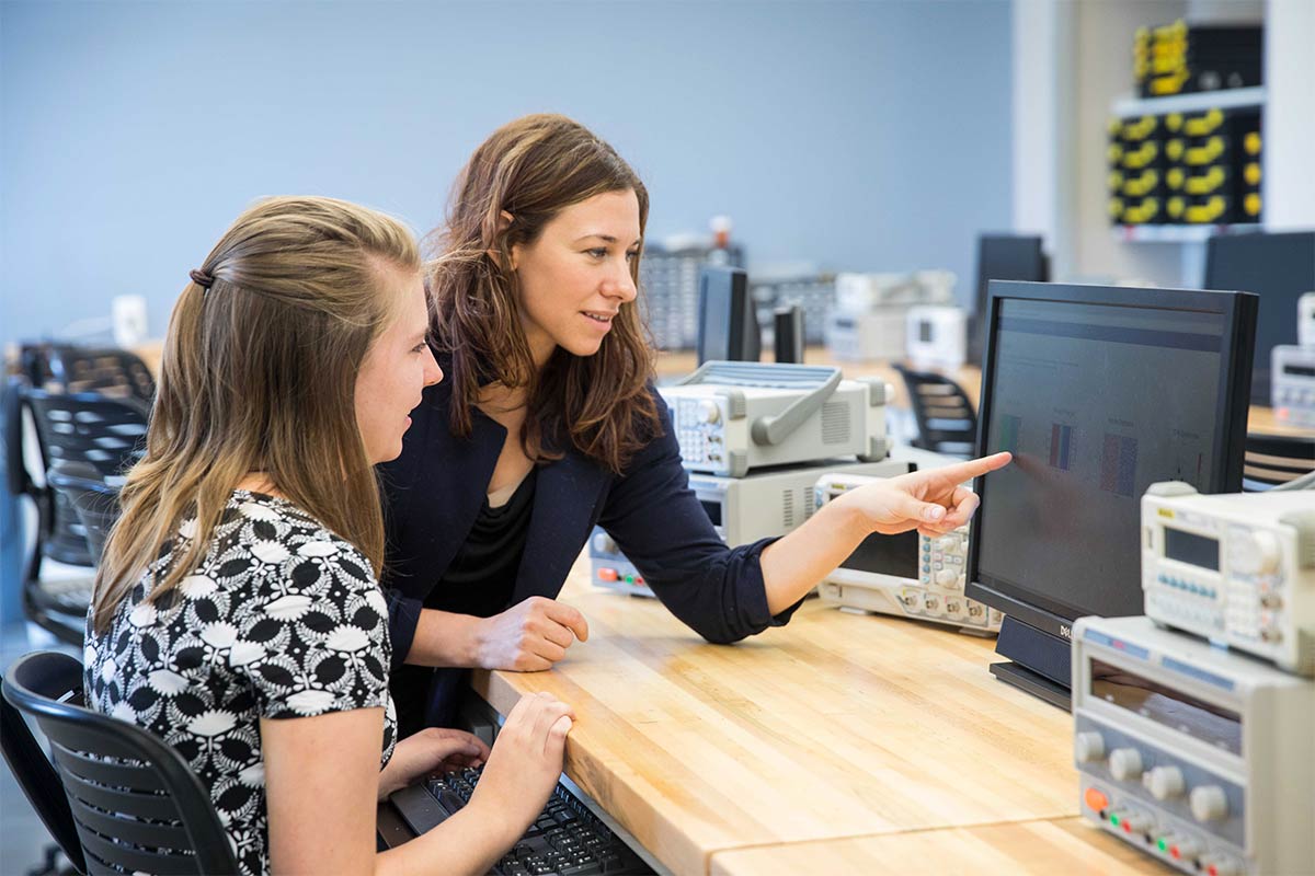 Stephanie Weeden-Wright, right, with student look at test output on a computer screen